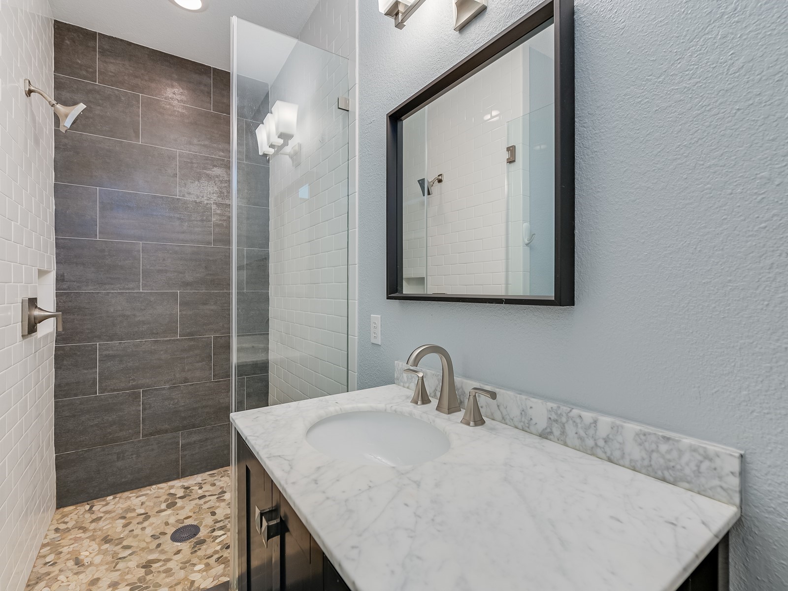 1115 Kinney Avenue, Unit 9 Austin, TX 78704 - Photo 13 of 19 Full bathroom with a textured wall, walk in shower, and vanity