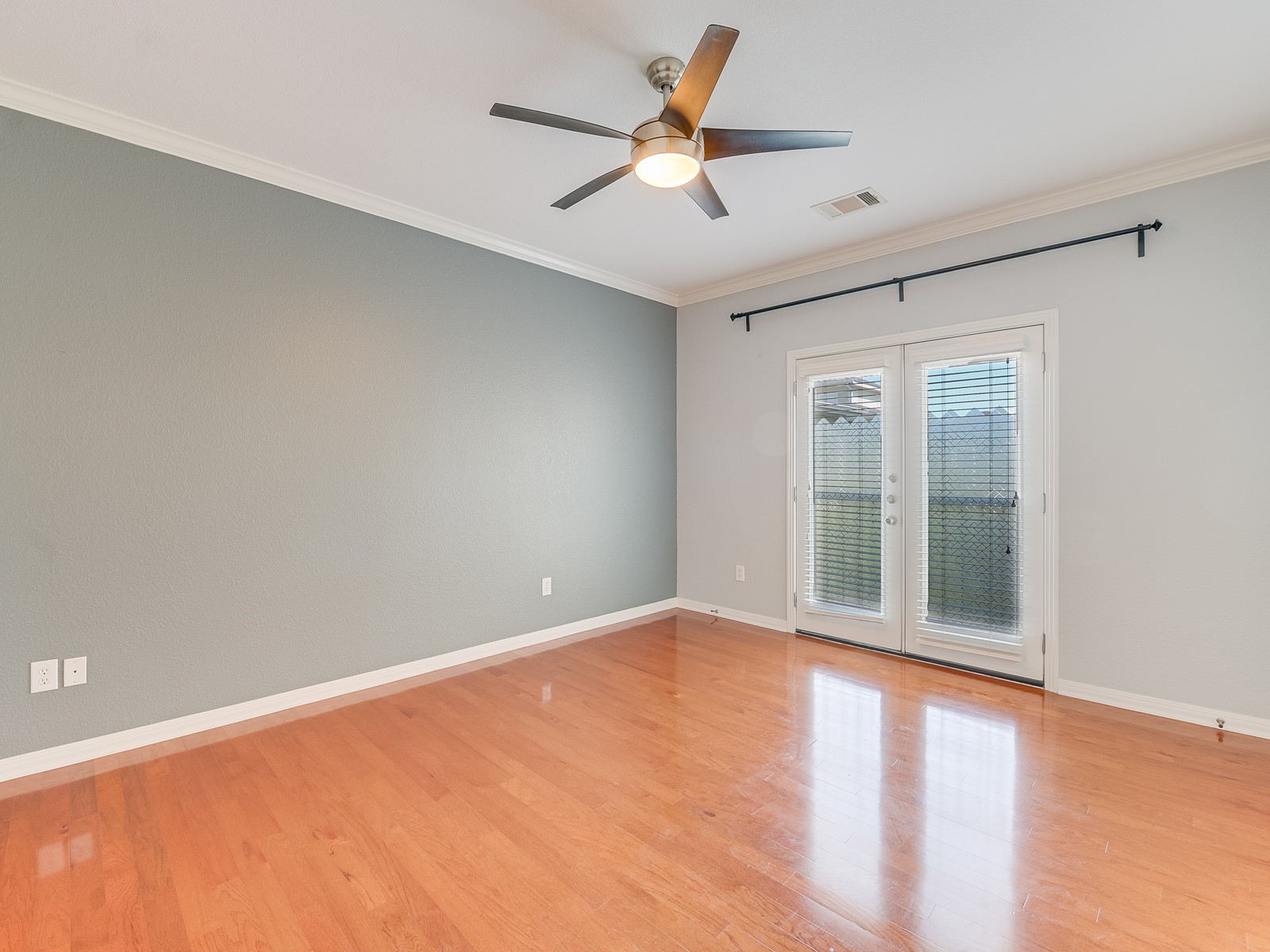 1115 Kinney Avenue, Unit 9 Austin, TX 78704 - Photo 14 of 19 Empty room featuring french doors, crown molding, visible vents, wood finished floors, and baseboards