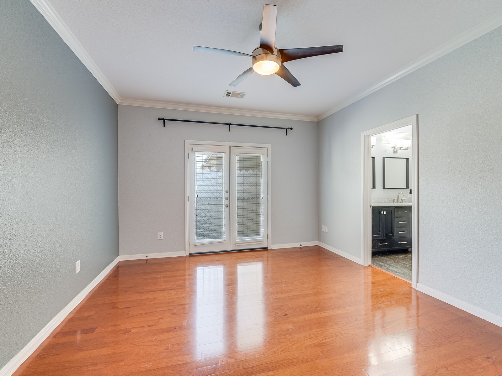 1115 Kinney Avenue, Unit 9 Austin, TX 78704 - Photo 15 of 19 Unfurnished room featuring french doors, crown molding, light wood finished floors, visible vents, and baseboards