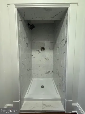 a bathroom with a glass door shower