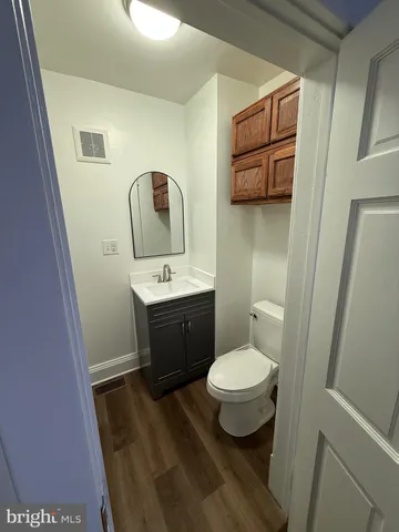 a bathroom with a toilet sink and mirror