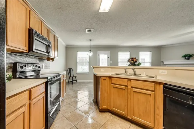 a kitchen with stainless steel appliances granite countertop a sink and cabinets