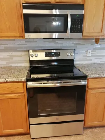 a stove top oven sitting inside of a kitchen