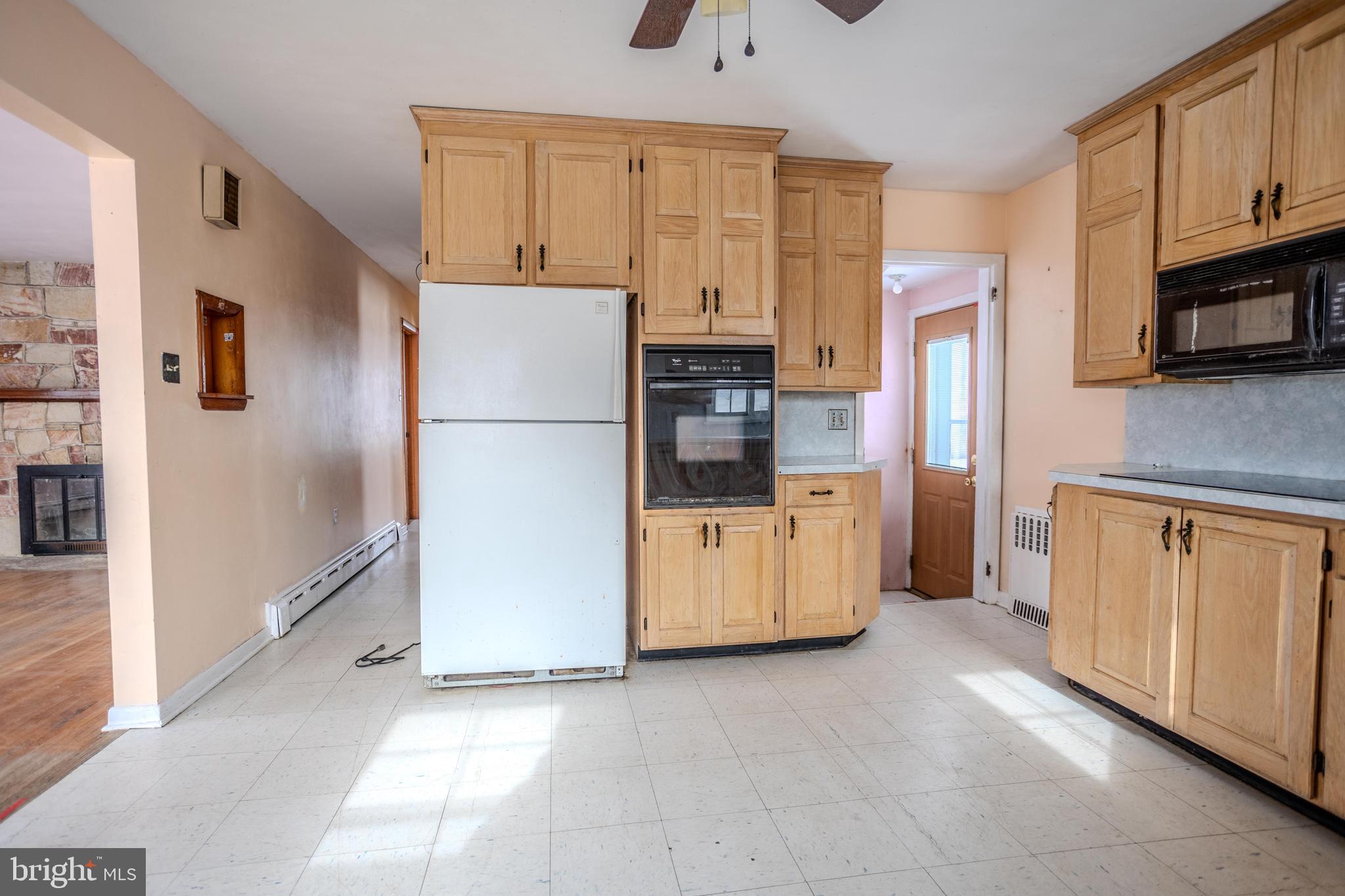 241 Wagner Road Chambersburg, PA 17202 - Photo 15 of 37 a kitchen with stainless steel appliances a refrigerator a stove a microwave and cabinets