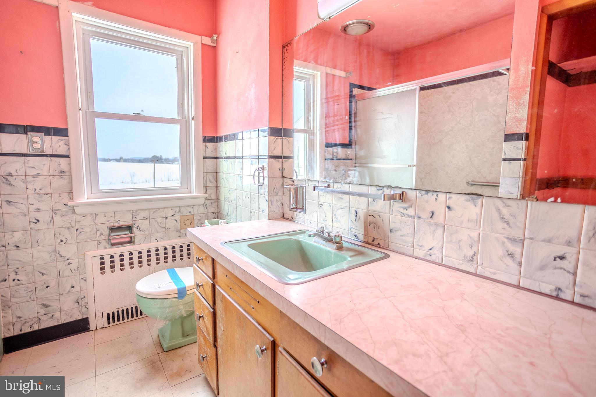 241 Wagner Road Chambersburg, PA 17202 - Photo 23 of 37 a bathroom with a granite countertop sink and a large mirror