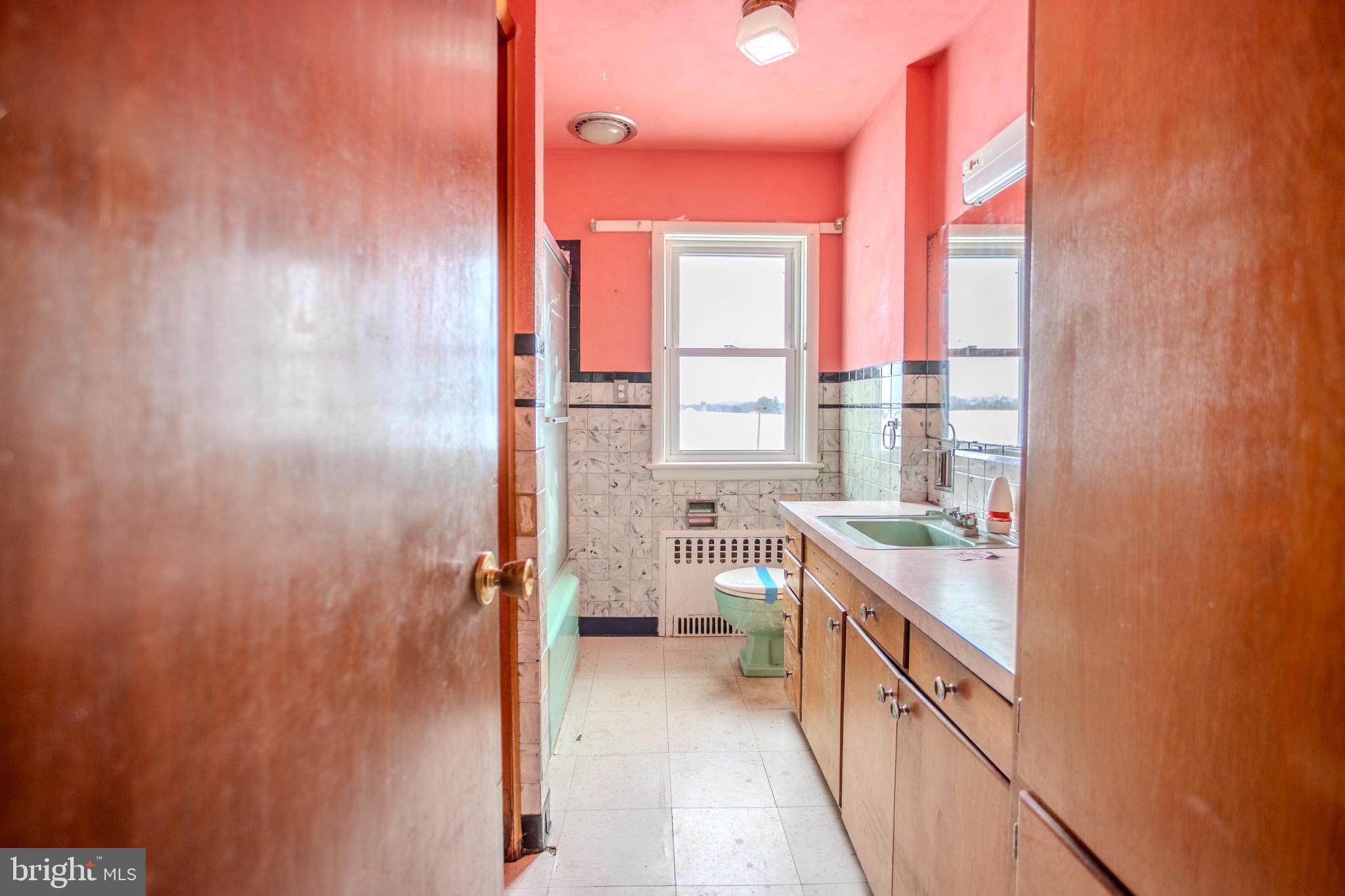 241 Wagner Road Chambersburg, PA 17202 - Photo 25 of 37 a bathroom with a granite countertop sink and a window