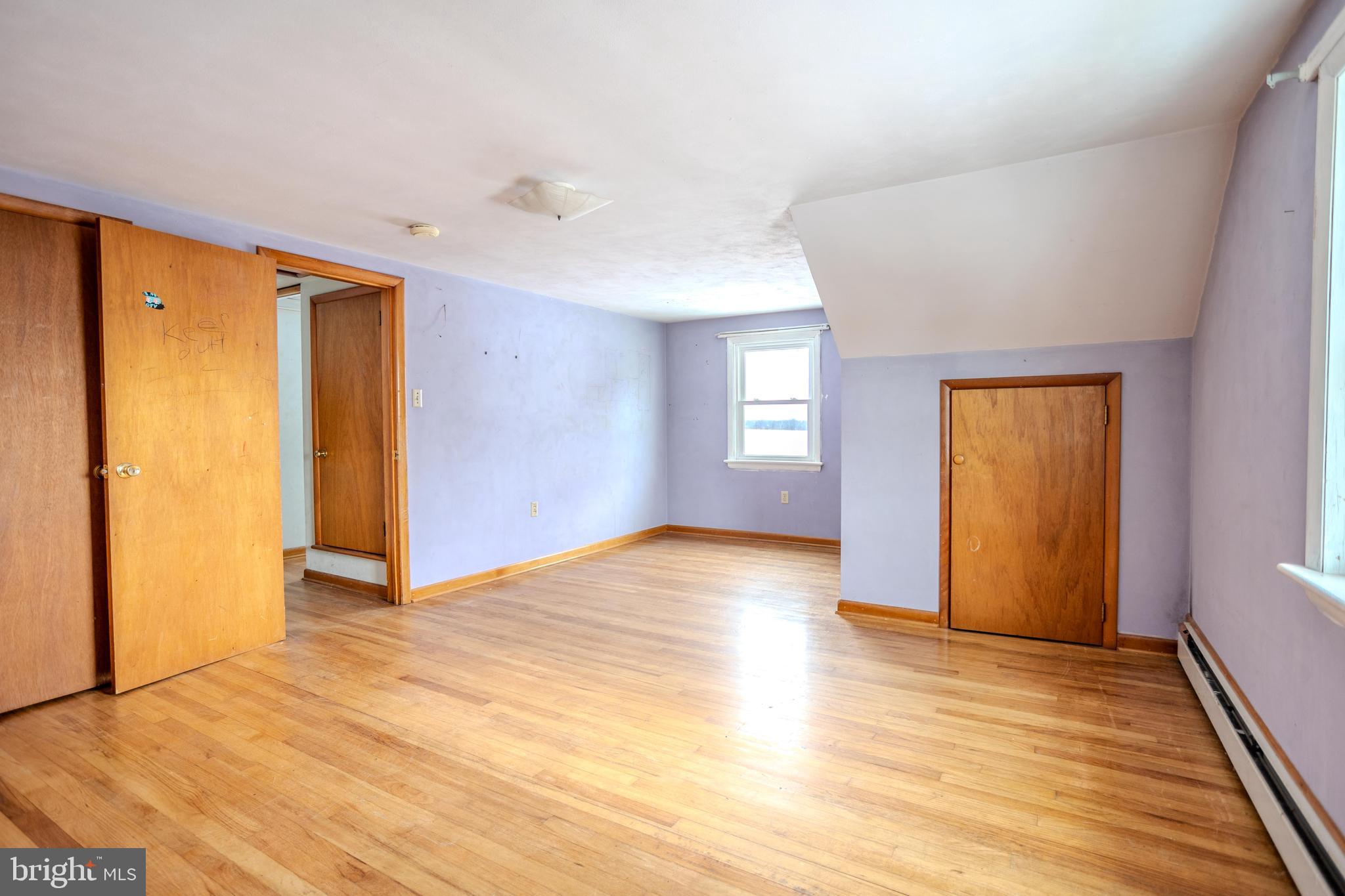 241 Wagner Road Chambersburg, PA 17202 - Photo 27 of 37 a view of an empty room with window and wooden floor