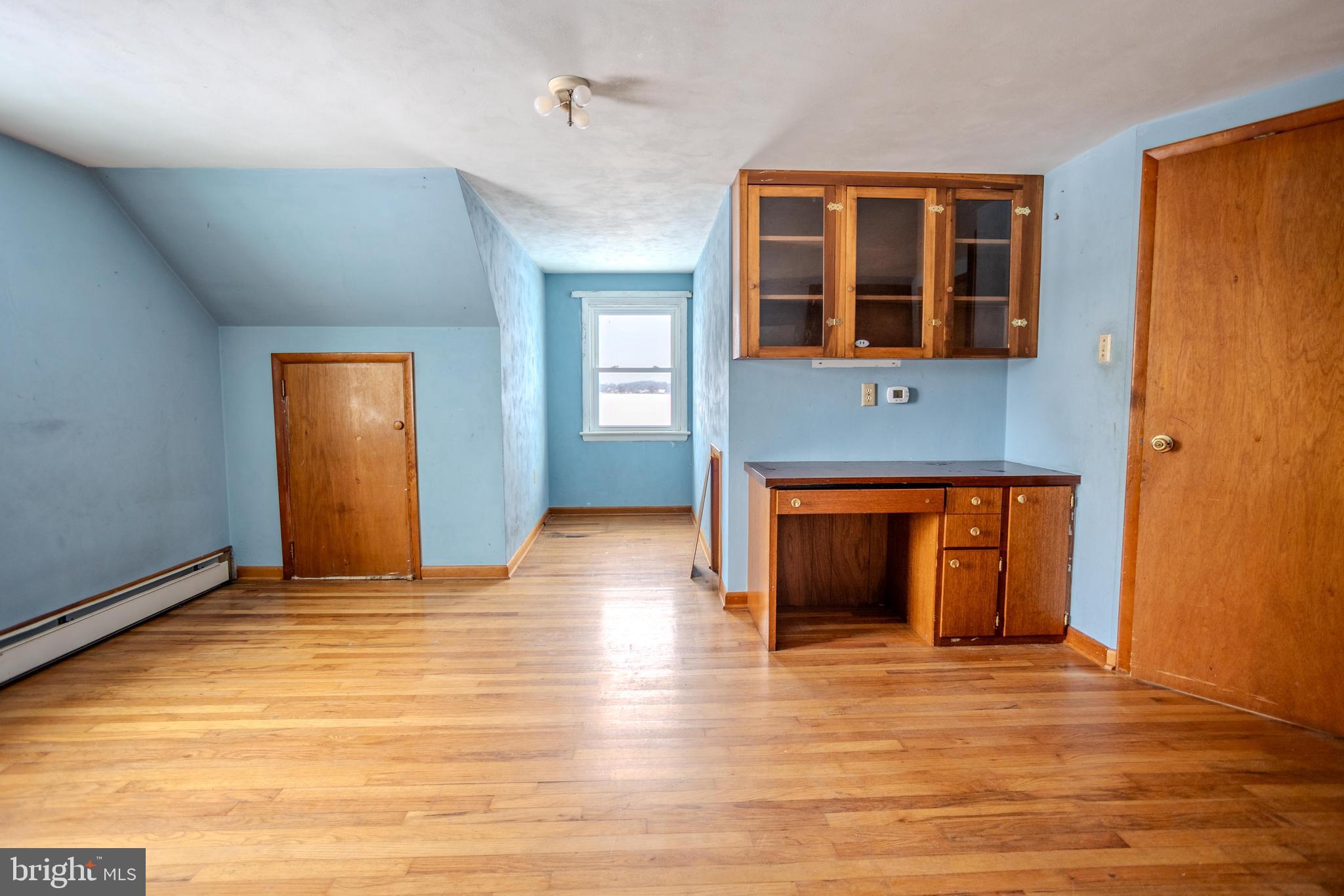 241 Wagner Road Chambersburg, PA 17202 - Photo 29 of 37 a view of an empty room with wooden floor and a window