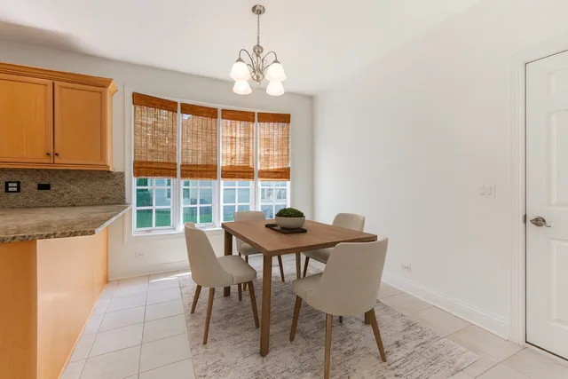 a view of a dining room with furniture and chandelier