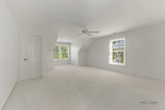an empty room with windows and closet