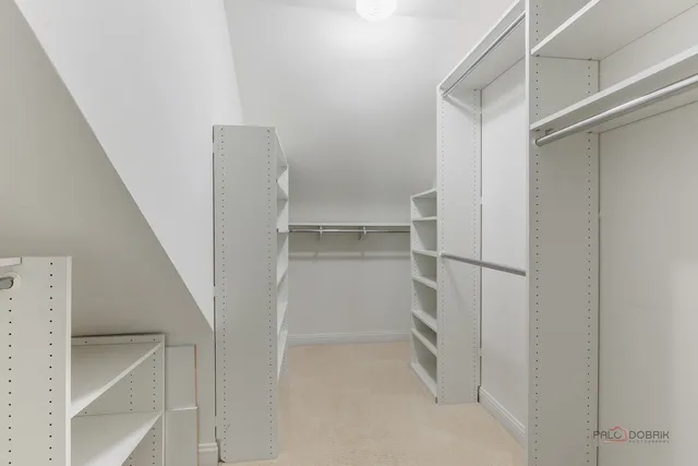 a view of walk in closet with empty racks