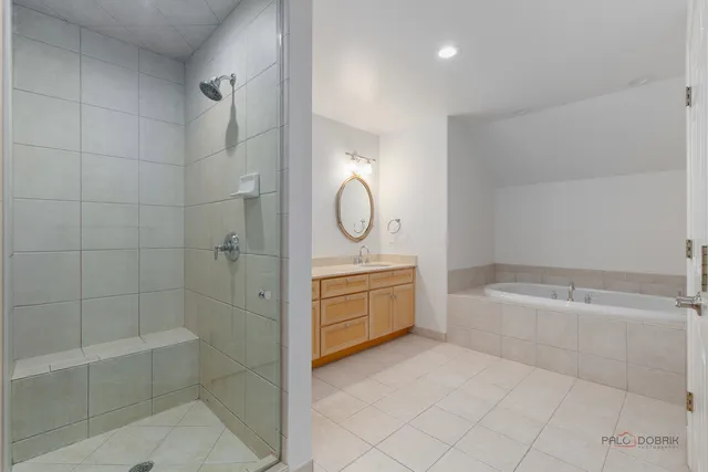 a spacious bathroom with a mirror a bathtub and a shower