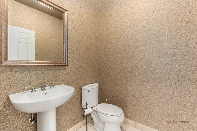 a bathroom with a sink a toilet and mirror