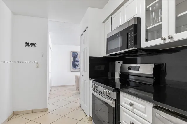 a kitchen with stainless steel appliances a stove and a microwave