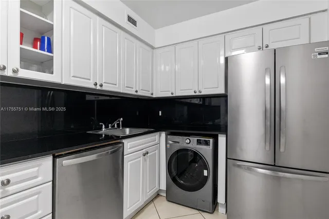 a kitchen with a sink and cabinets