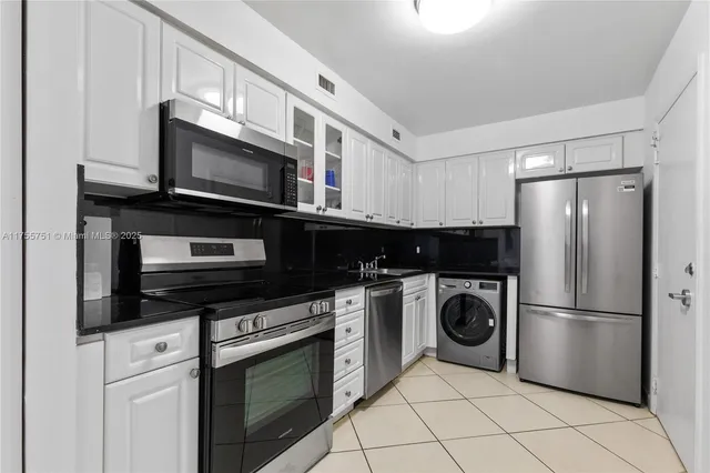 a kitchen with a refrigerator stove and microwave