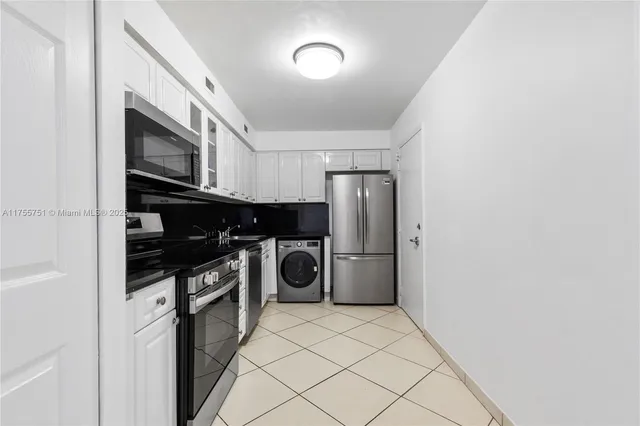 a kitchen with a refrigerator and a stove top oven
