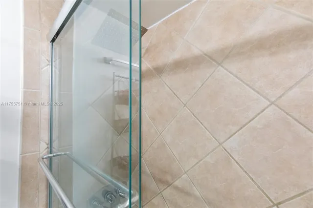 a bathroom with a glass shower door
