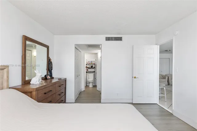 a room with a dresser and mirror