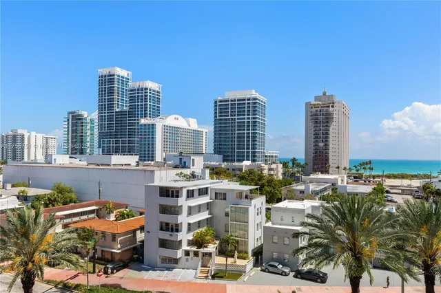 a view of a room with lots of furniture and wooden floor