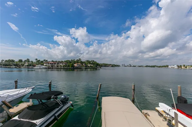 a front view of building with yard and sign board