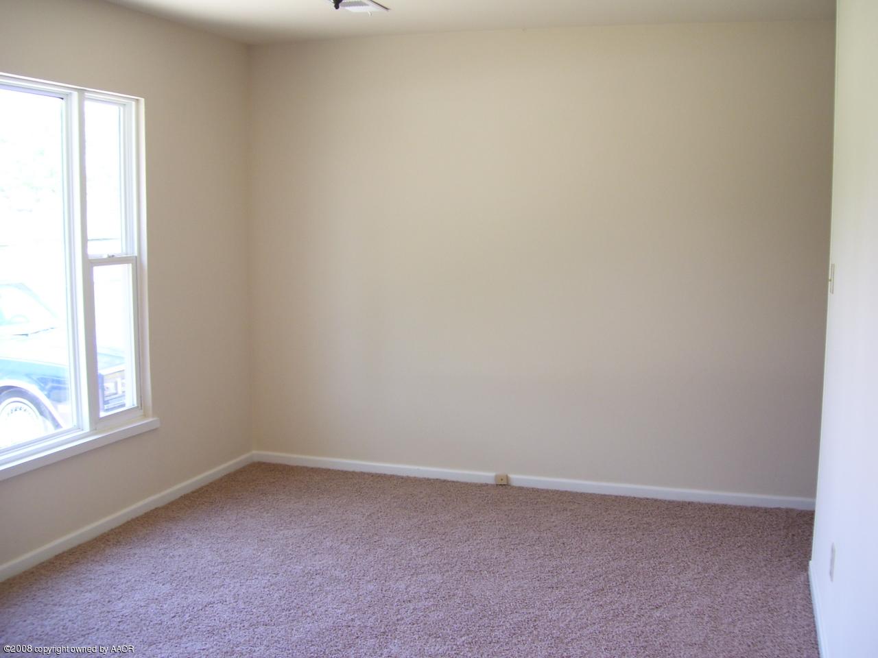 4641 Parker Street Amarillo, TX 79110 - Photo 3 of 8 an empty room with a window