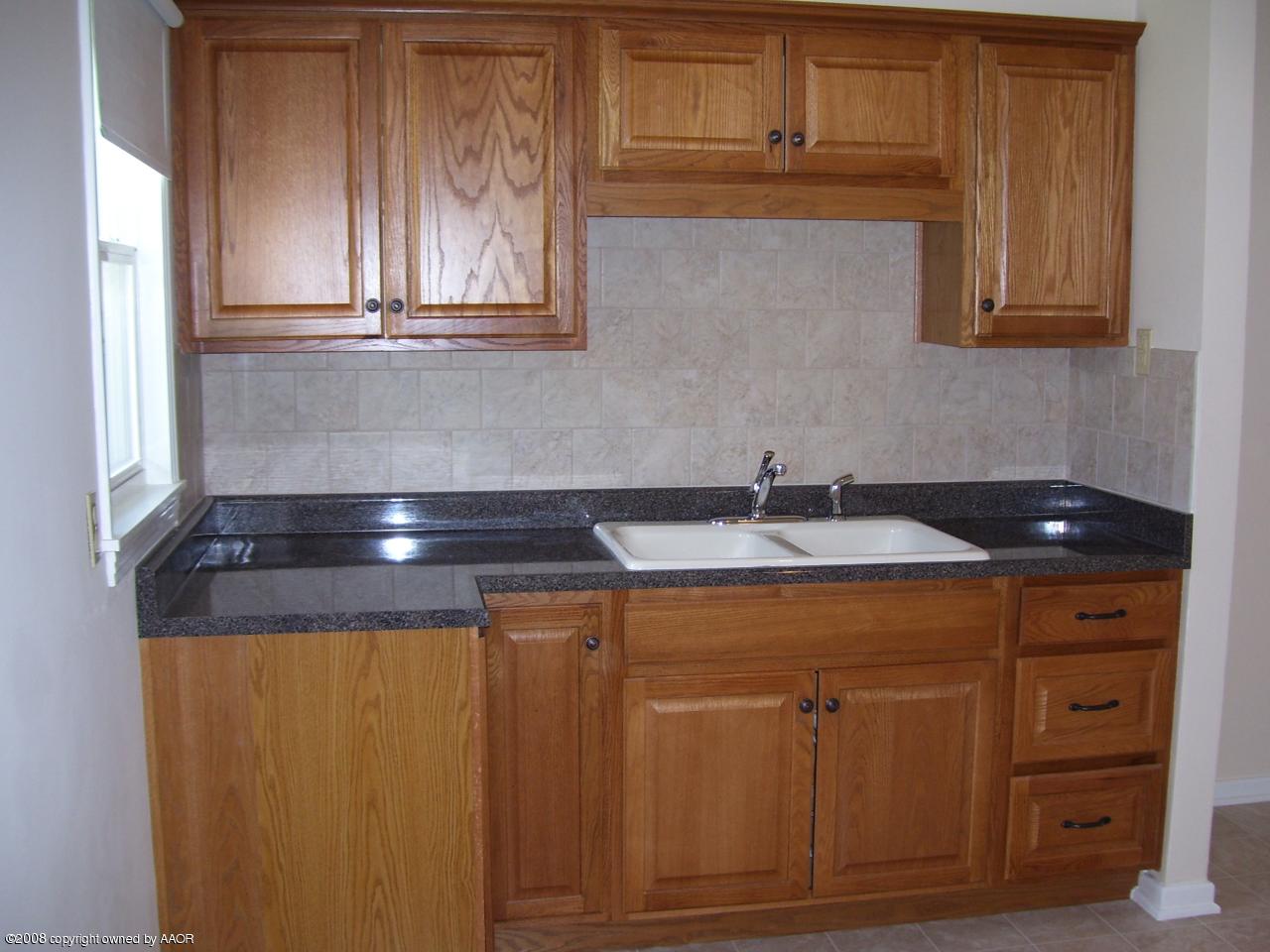 4641 Parker Street Amarillo, TX 79110 - Photo 4 of 8 a kitchen with a sink and cabinets