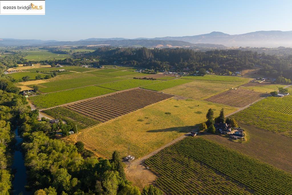 838 Dry Creek Road Healdsburg, CA 95448 - Photo 20 of 22 Aerial view of property and surrounding area with a mountain backdrop, rural landscape, and large plots for crops