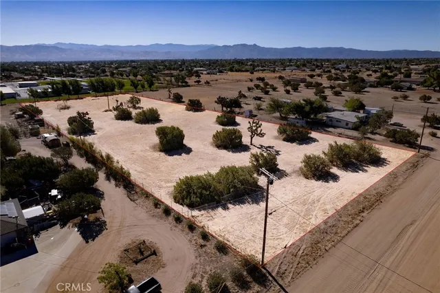 a view of a terrace with lawn chairs