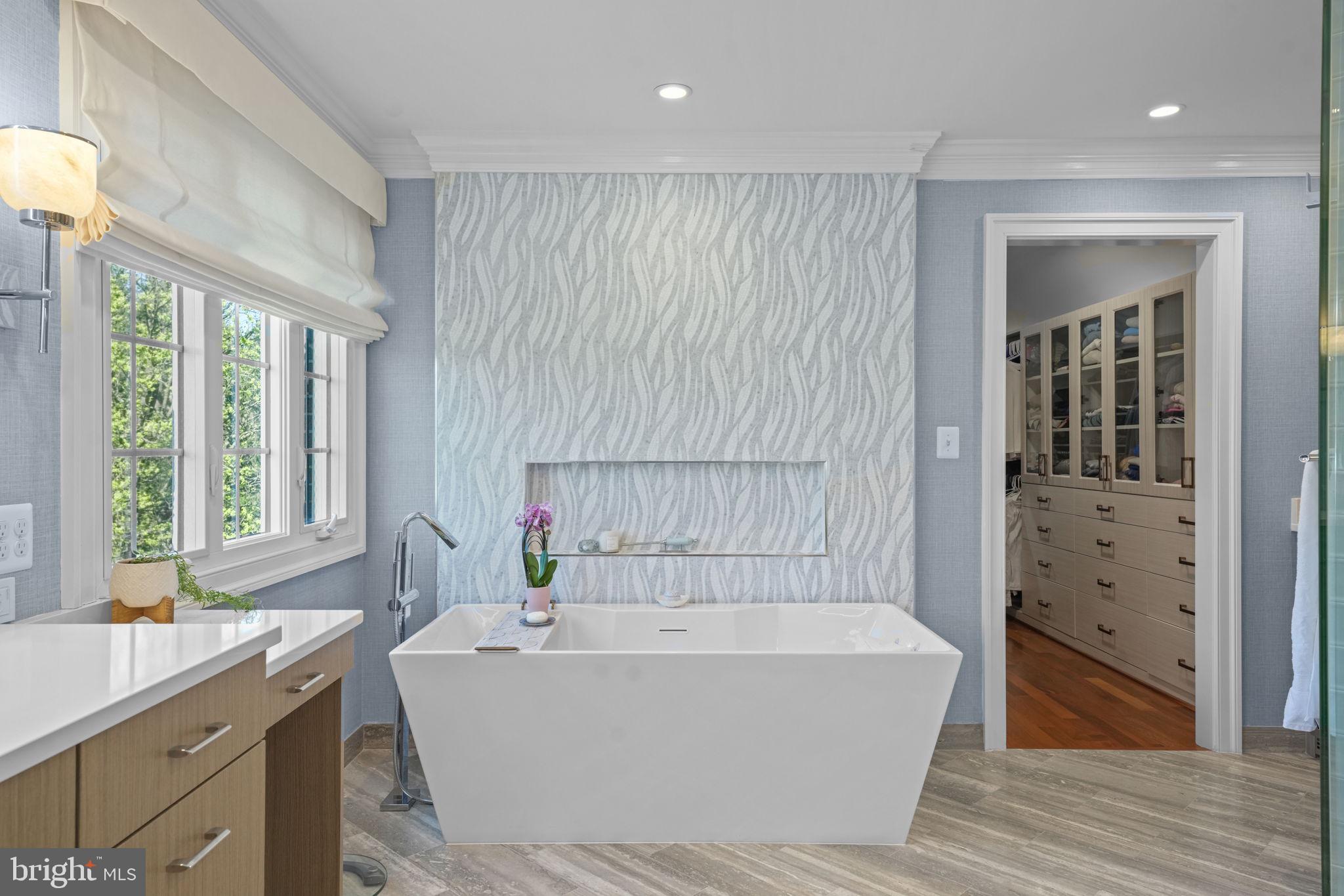 11431 Woolington Road Great Falls, VA 22066 - Photo 26 of 49 a white bath tub sitting in a bathroom next to a window