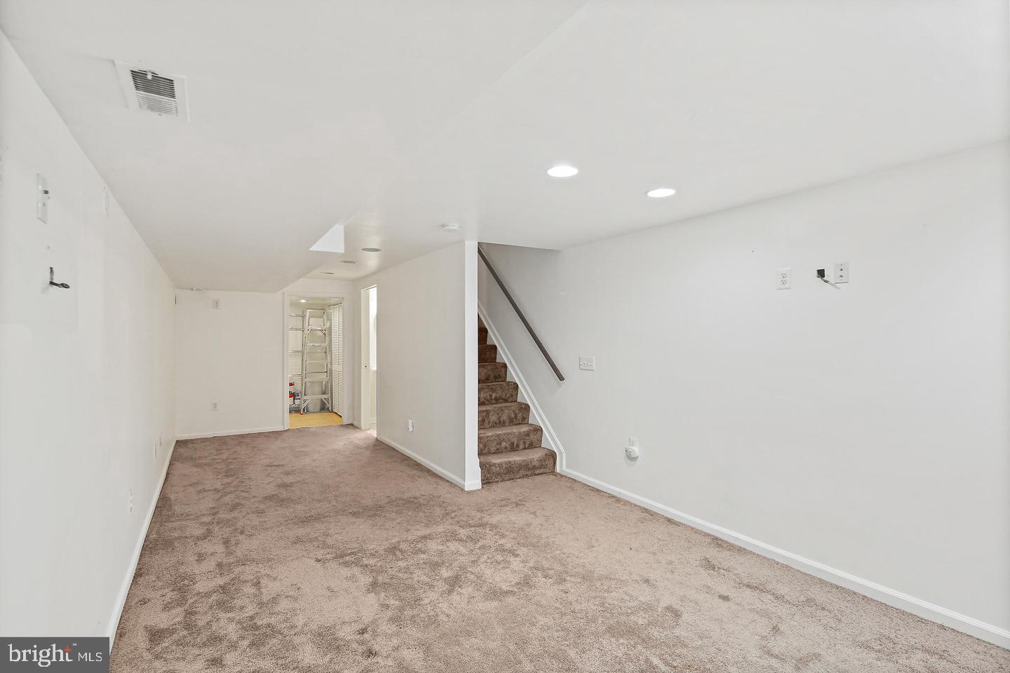 1723 Clarkson Street Baltimore, MD 21230 - Photo 11 of 27 wooden floor in an empty room with stairs