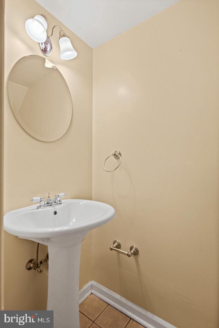 1723 Clarkson Street Baltimore, MD 21230 - Photo 13 of 27 a bathroom with a sink a mirror and vanity