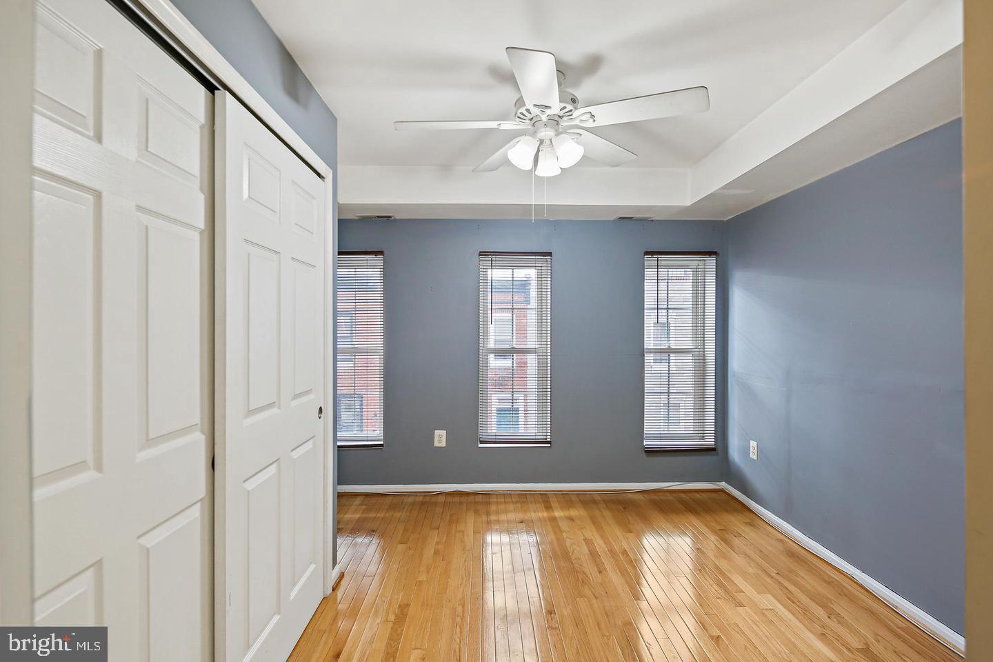 1723 Clarkson Street Baltimore, MD 21230 - Photo 15 of 27 a view of an empty room with wooden floor and a window