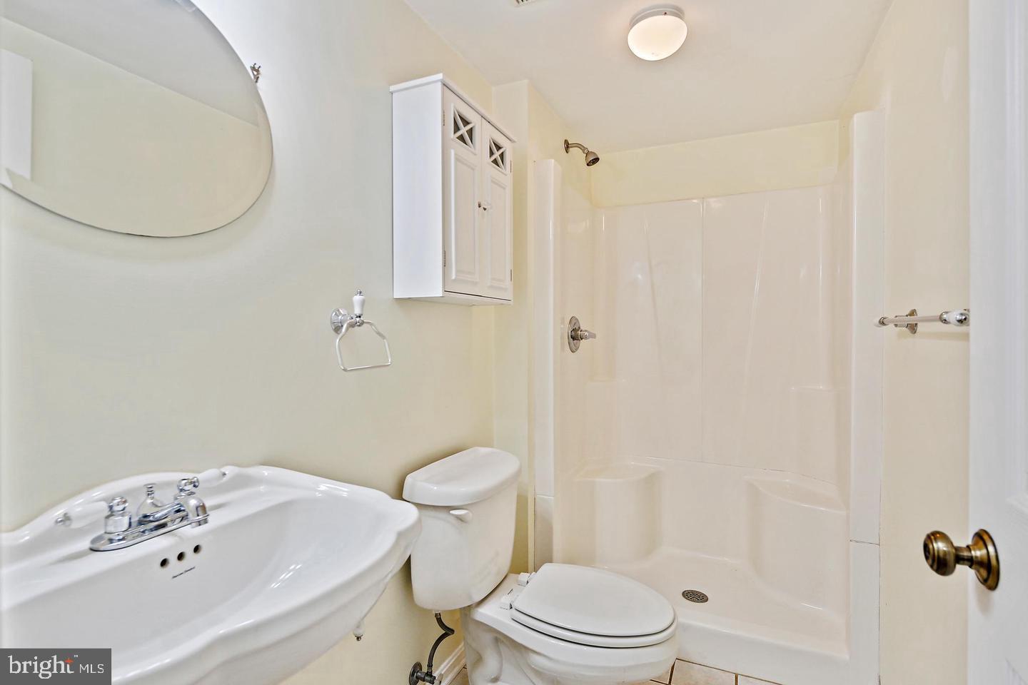1723 Clarkson Street Baltimore, MD 21230 - Photo 17 of 27 a bathroom with a sink a toilet and shower