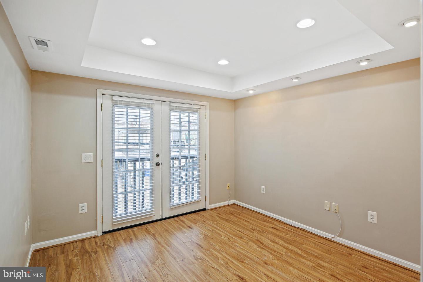 1723 Clarkson Street Baltimore, MD 21230 - Photo 18 of 27 a view of an empty room with wooden floor and a window