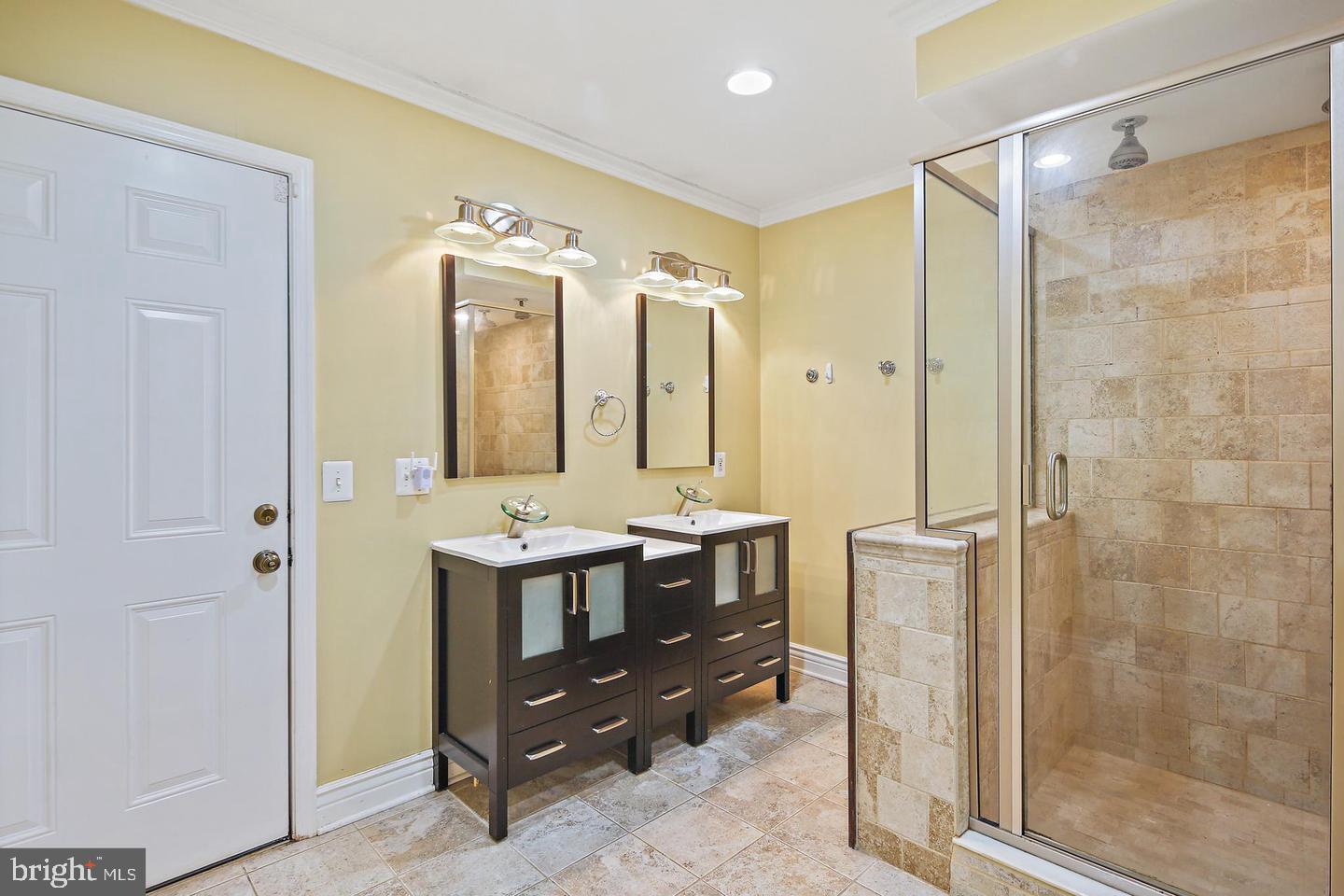 1723 Clarkson Street Baltimore, MD 21230 - Photo 20 of 27 a bathroom with a double vanity sink mirror and shower