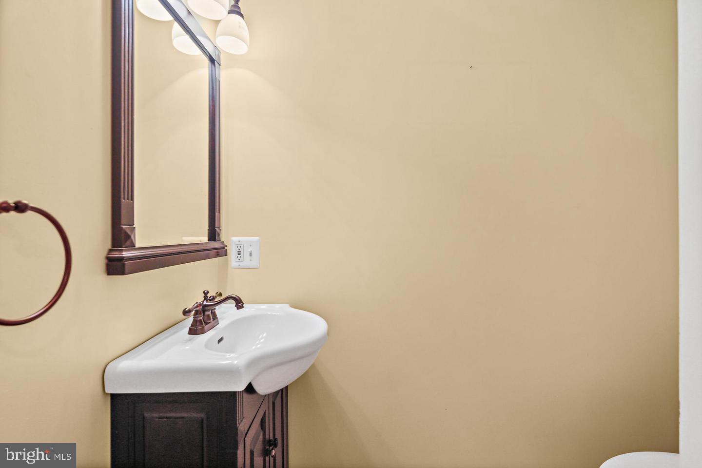 1723 Clarkson Street Baltimore, MD 21230 - Photo 9 of 27 a bathroom with a sink and a mirror