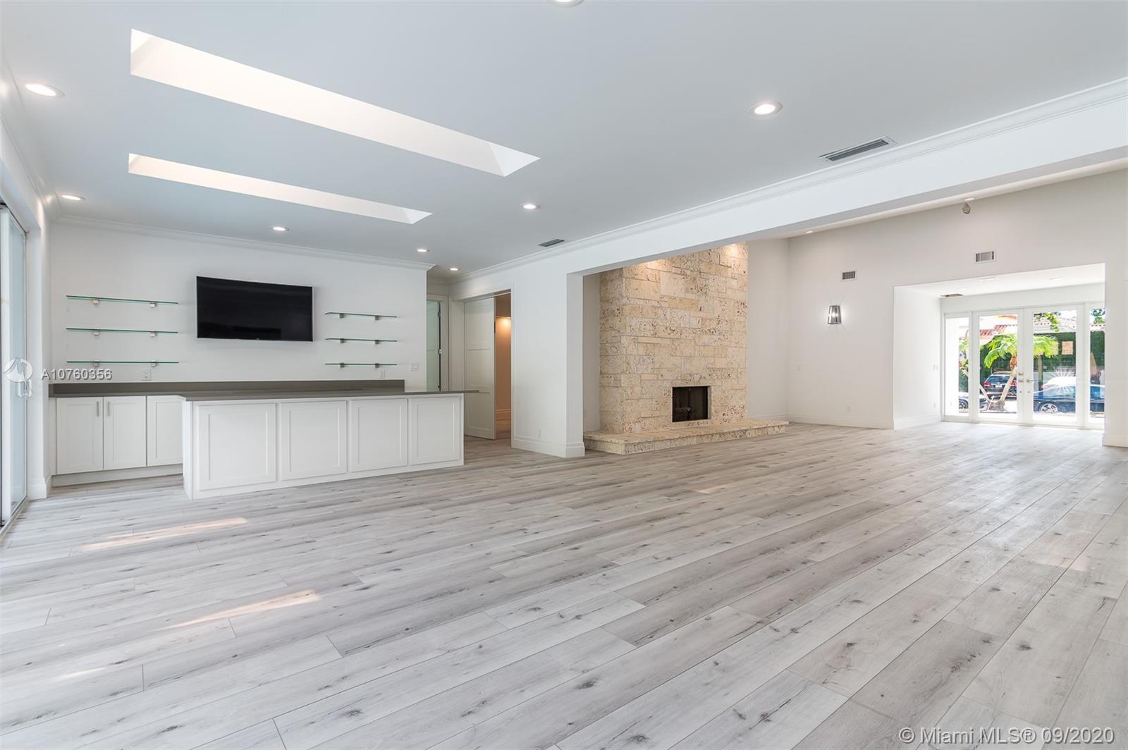 575 Sandpiper Way Boca Raton, FL 33431 - Photo 24 of 56 New Custom Built Bar featuring wine cooler, flat screen TV, and seating for 6! Adjacent to open living room and fireplace.