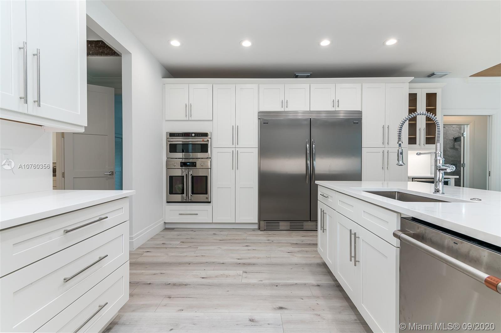 575 Sandpiper Way Boca Raton, FL 33431 - Photo 6 of 56 Brand New XXL open chef's kitchen featuring Top of the Line SS appliances, chrome finishes, custom wood shaker cabinets, quartz countertops and back splash, endless seating and storage!