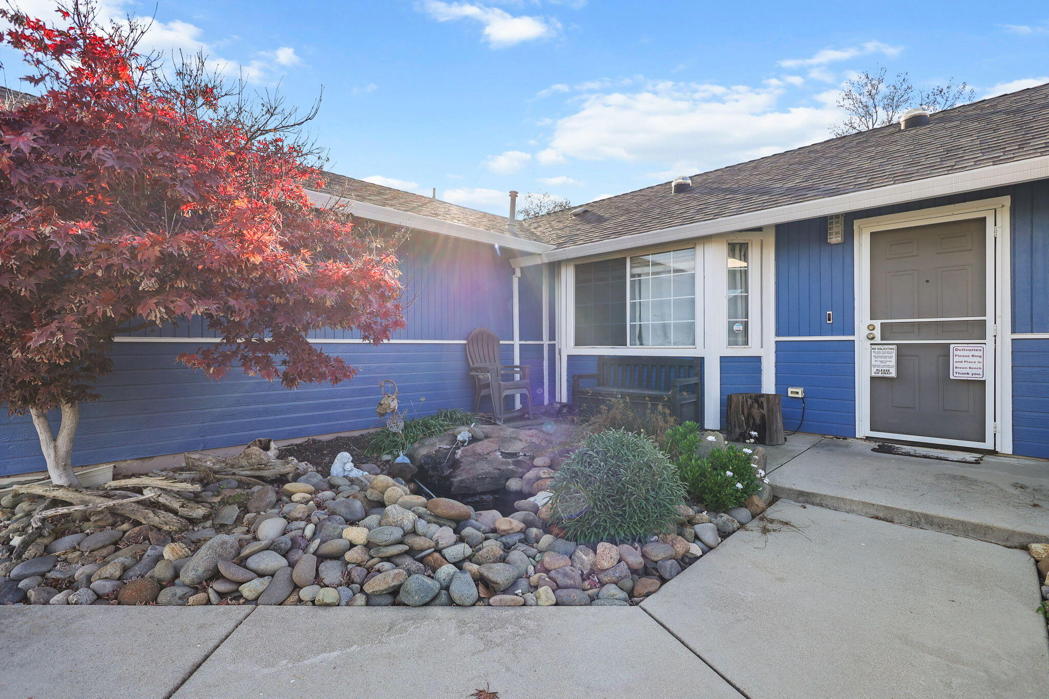 7060 Pit Road Redding, CA 96001 - Photo 2 of 26 front view of a house with a bench
