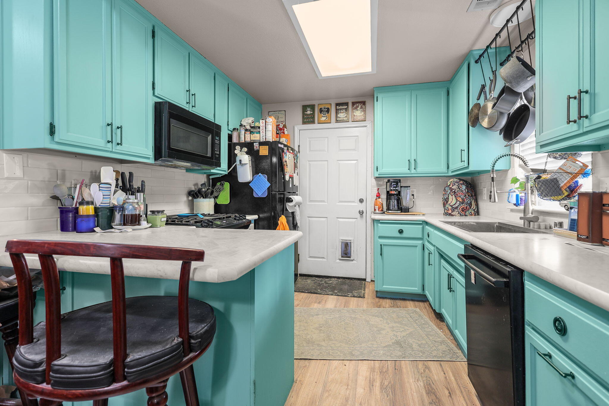 7060 Pit Road Redding, CA 96001 - Photo 4 of 26 a kitchen with stainless steel appliances a table chairs sink and cabinets