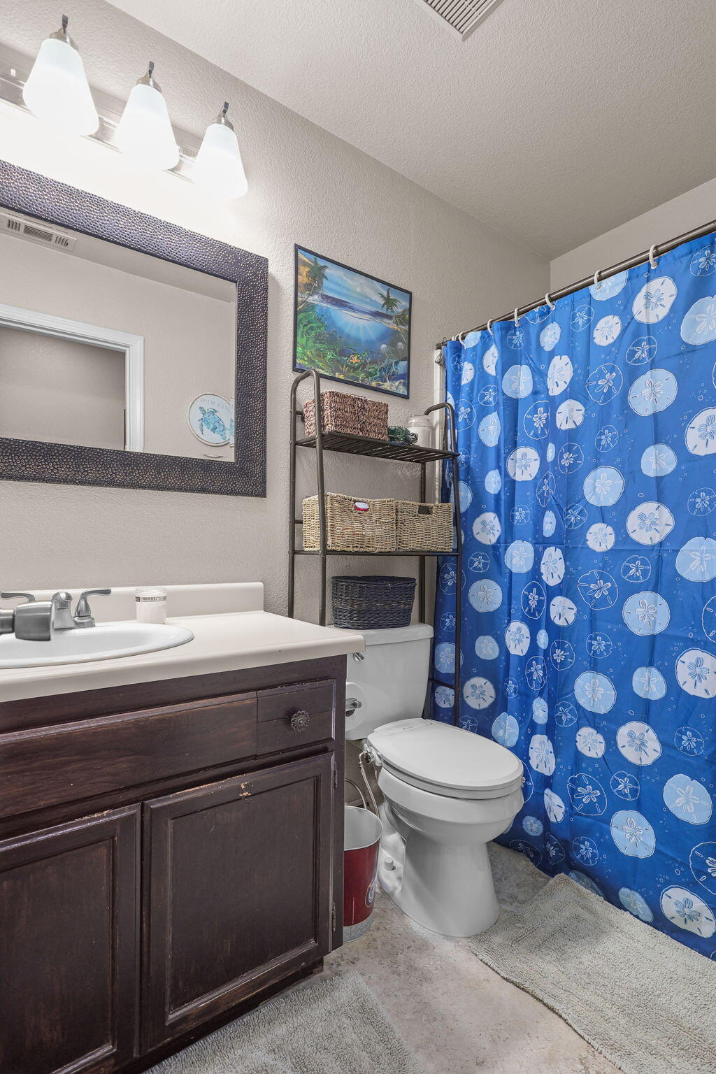 7060 Pit Road Redding, CA 96001 - Photo 7 of 26 a bathroom with a granite countertop toilet a sink and a mirror