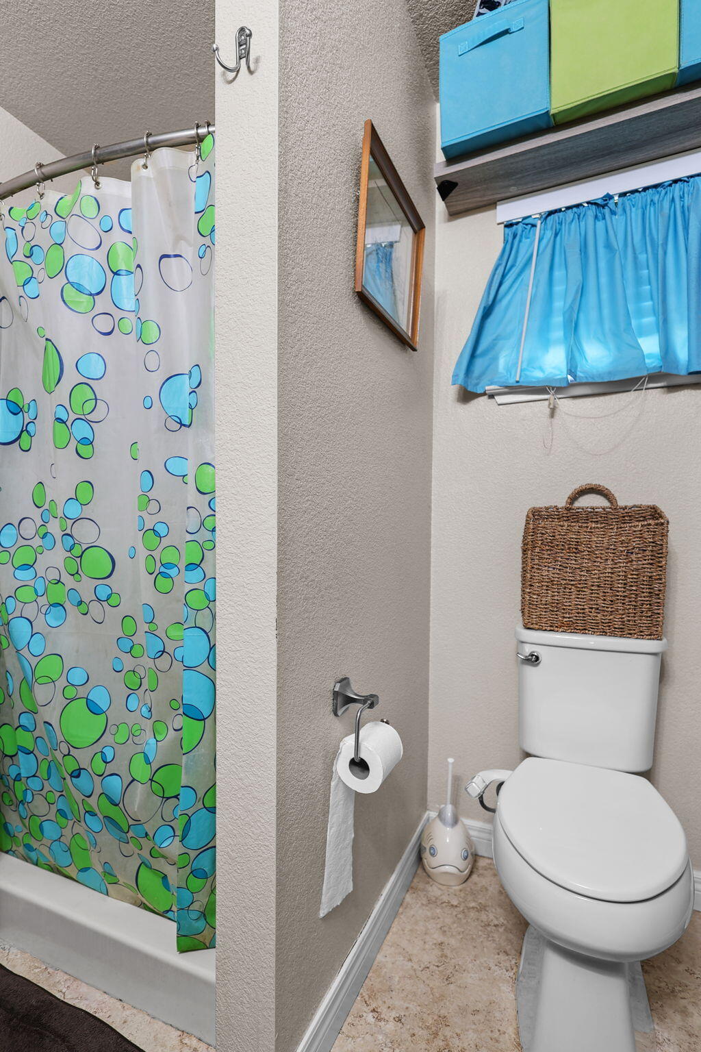 7060 Pit Road Redding, CA 96001 - Photo 9 of 26 a bathroom with a toilet and a shower curtain