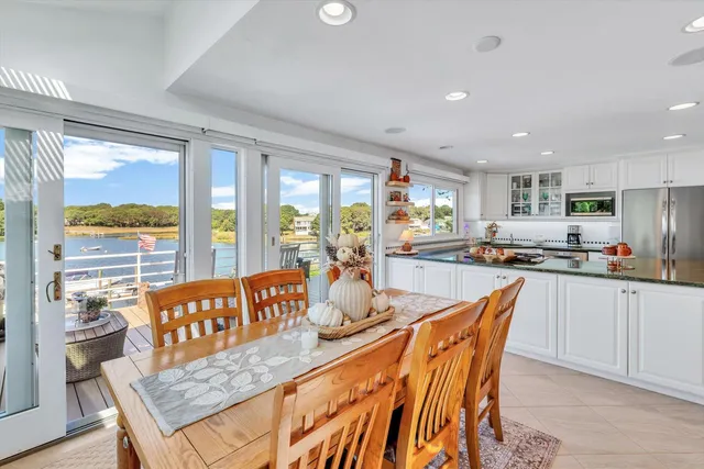 a living room with furniture potted plant and a large window