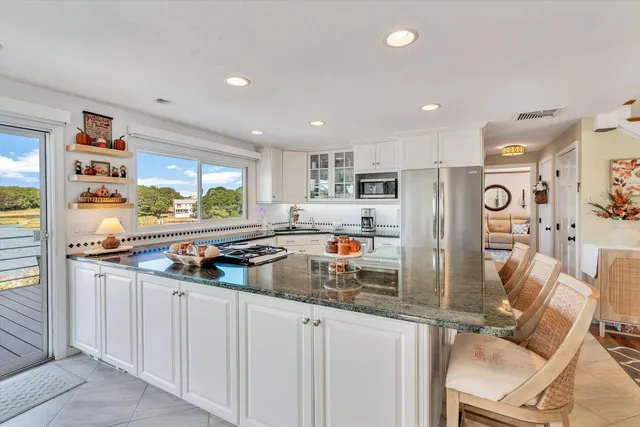a living room with furniture fireplace and a large window