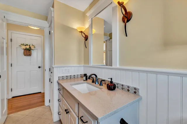 a en suite bathroom with a granite countertop double vanity