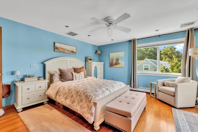 a living room with furniture a flat screen tv and a floor to ceiling window