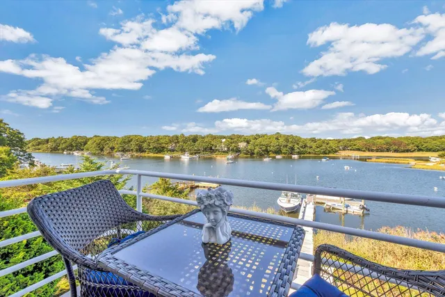 a bathroom with a refrigerator sink and mirror