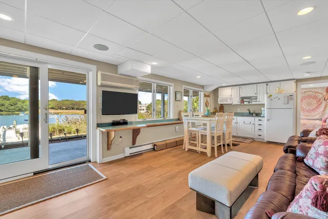 a view of a patio with table and chairs with wooden floor and fence