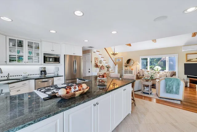 a living room with furniture and kitchen view